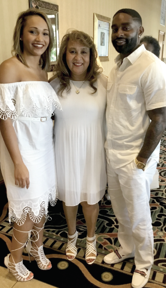 Jerre Curry surrounded by her daughter, Shae Curry (left) and Shae's fiancé Jared.