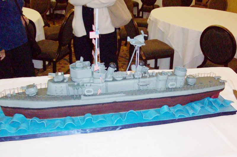 Reunion organizers for the USS Floyd B. Parks reunion added a festive touch to their catered dinner by having a local bakery bake a cake in the shape of the ship. Far more fun -- and more memorable -- than a standard sheet cake for dessert!