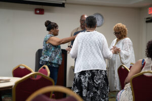 Siblings giving the closing Prayer Circle and blessing over the family.