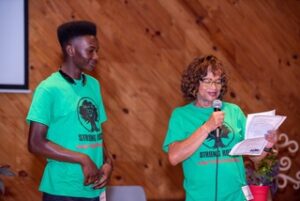 Carol Burger presenting scholarship to Tyrell Lampkin. 