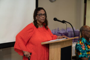 Evie Mitchell reading a poem at the meet and greet.