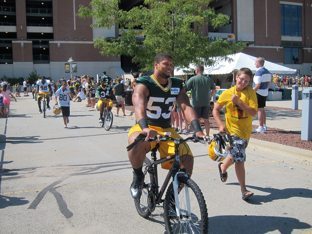 Nick Perry (53) leads a parade of players on the way to practice. Click to enlarge.